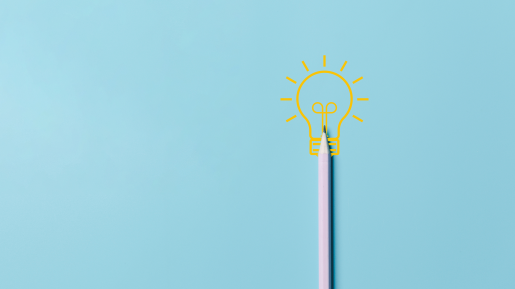 A pastel pink pencil standing upright on a light blue background, with a glowing yellow lightbulb illustration above it, symbolizing creativity, inspiration, and the writing process.